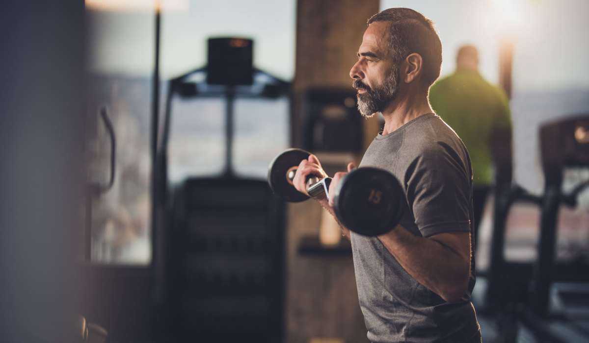A man doing workouts in the fitness center at Timber Ridge Townhomes in Bay Minette, Alabama