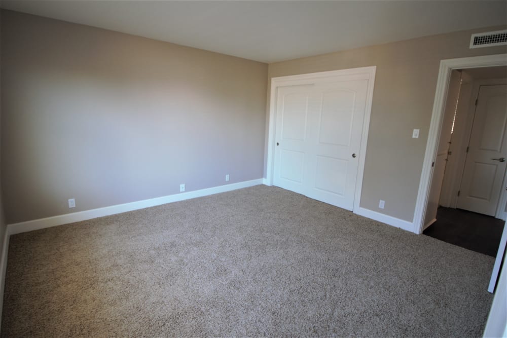 Model bedroom with large closet at Pinebrook Apartment Homes in Fremont, California