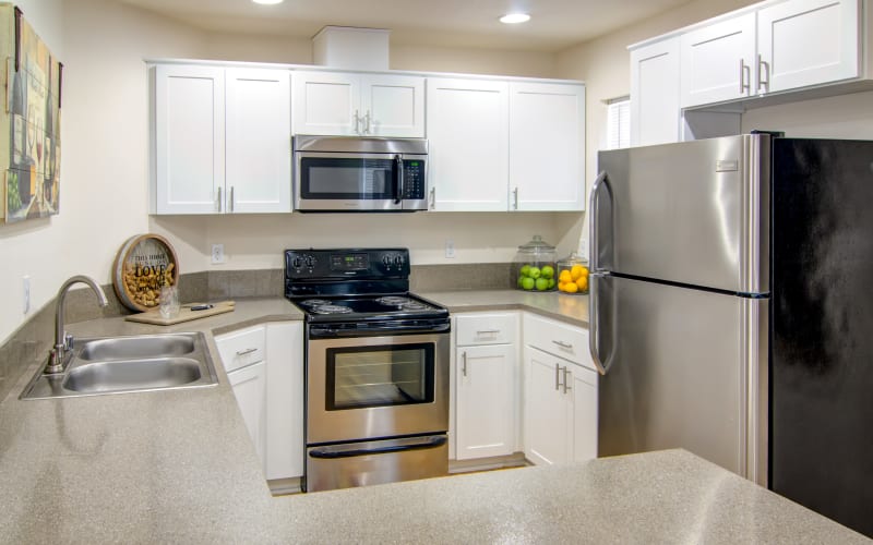 Renovated kitchen with white cabinets at The Addison Apartments in Vancouver, Washington
