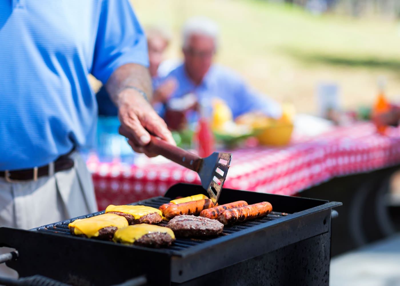 Man grilling outside at Lincoln Park Towers in Newark, New Jersey