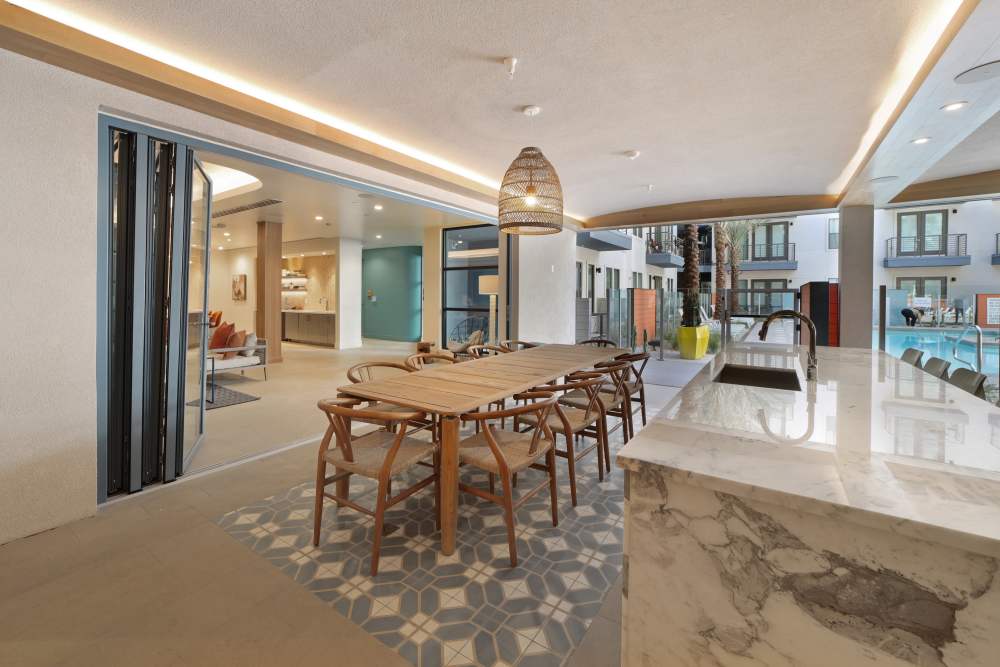 Spacious clubhouse with a table and multiple chairs at Lydian in Phoenix, Arizona