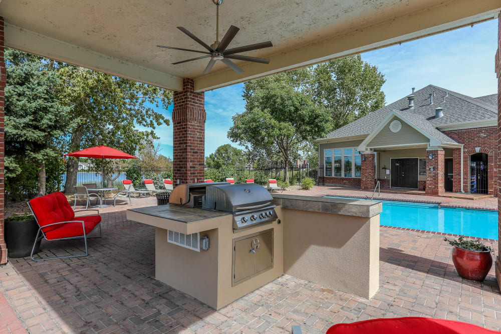 Poolside covered grilling area with bar top seating at Promenade at Hunter's Glen Apartments in Thornton, Colorado