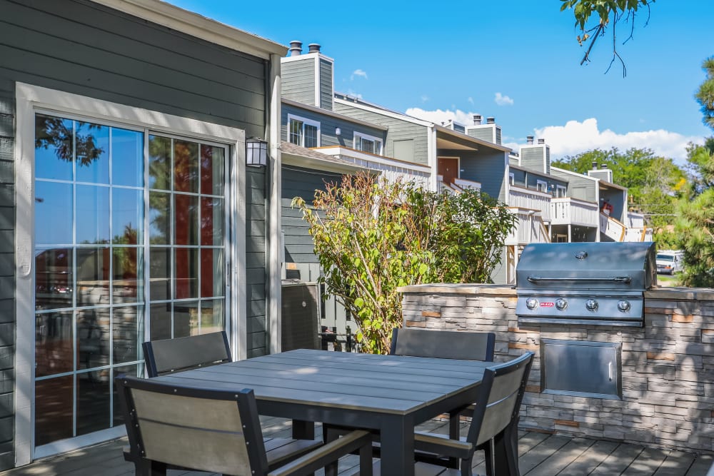 Outdoor seating area with a barbecue at Bluesky Landing Apartments in Lakewood, Colorado