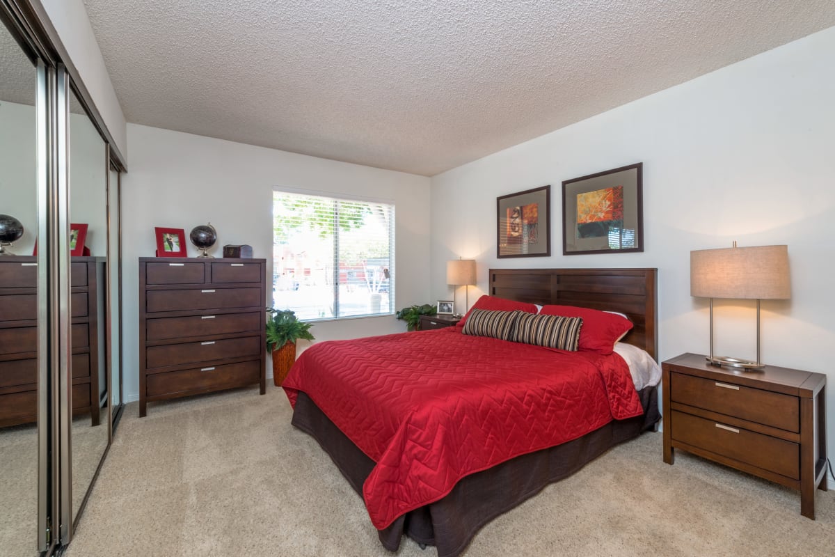 A bedroom with mirrored closet doors at River Ranch, Simi Valley, California