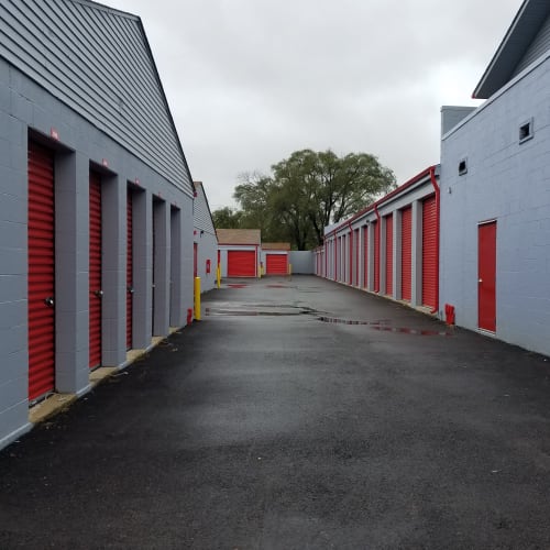 Outdoor storage units with red doors at Red Dot Storage in North Aurora, Illinois