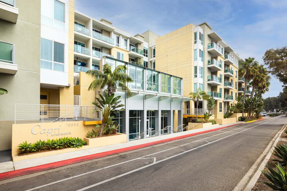 Palm trees line the entrance of luxury apartments at Capri Apartments in Marina Del Rey, California
