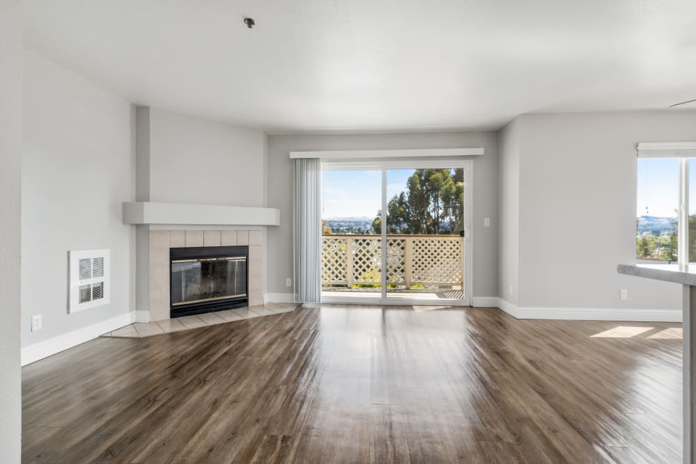 Spacious apartment with wood-style flooring at Quail Hill Apartments in Castro Valley, California