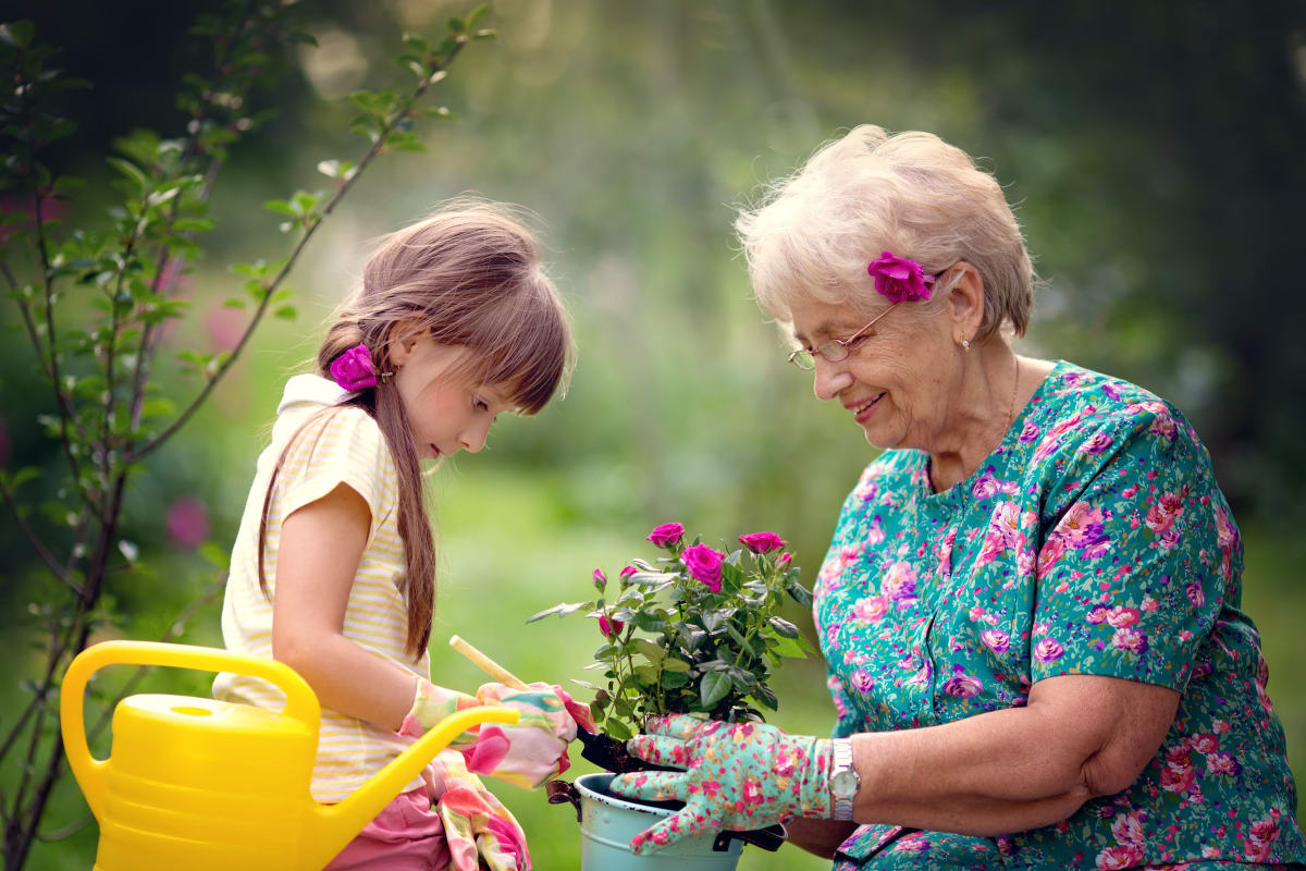 A resident and a small child planting flowers at Keystone Place at LaValle Fields in Hugo, Minnesota