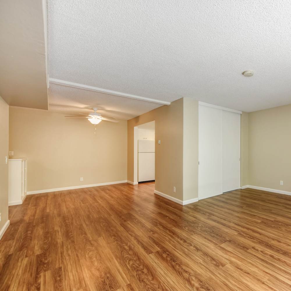 Spacious living room with wood-style flooring at Fayette Arms Apartments in Mountain View, California, 