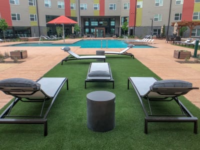Lounge area with chairs near pool at Terra at University North Park in Norman, Oklahoma