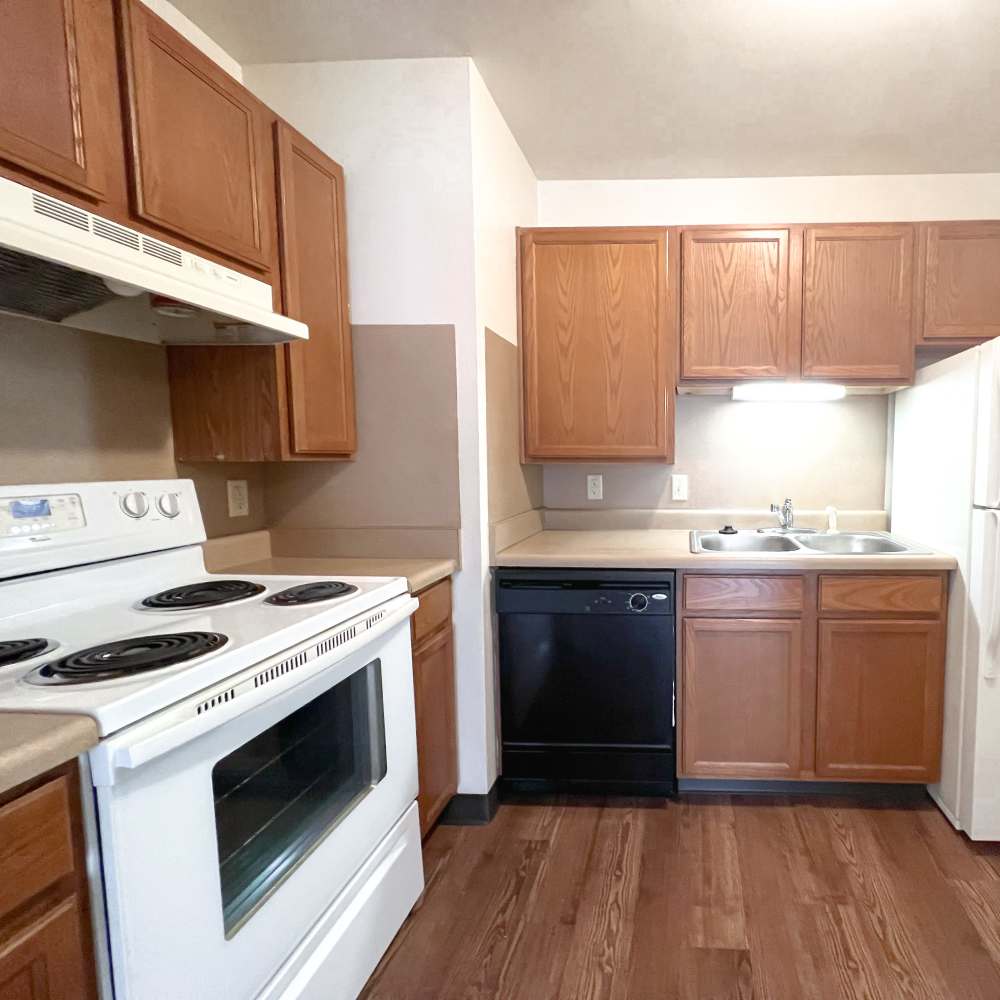 Kitchen with white color appliances at Rolling Brook Apartments in Algonac, Michigan