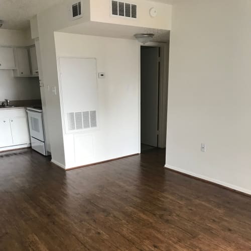 Wood-style flooring in a home at Arbors on 31st in Bryan, Texas