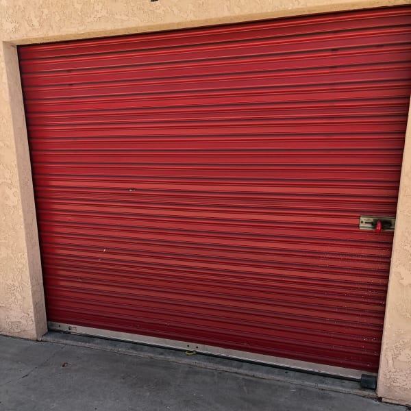Outdoor storage unit with a red door at StorQuest Self Storage in San Fernando, California