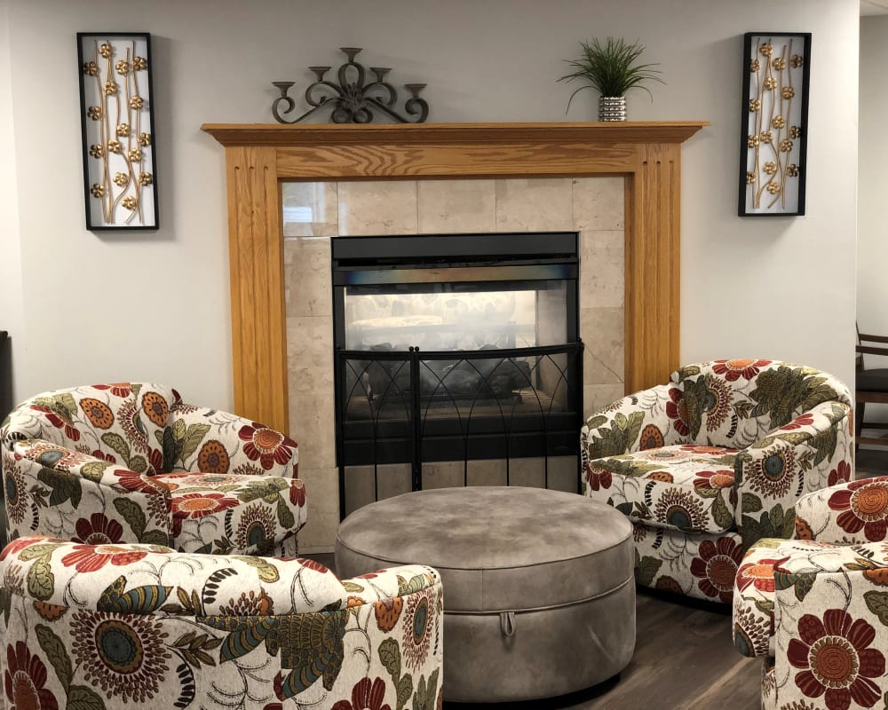 Community space for residents with fireplace and comfortable furniture at Corridor Crossing Place in Cedar Rapids, Iowa.
