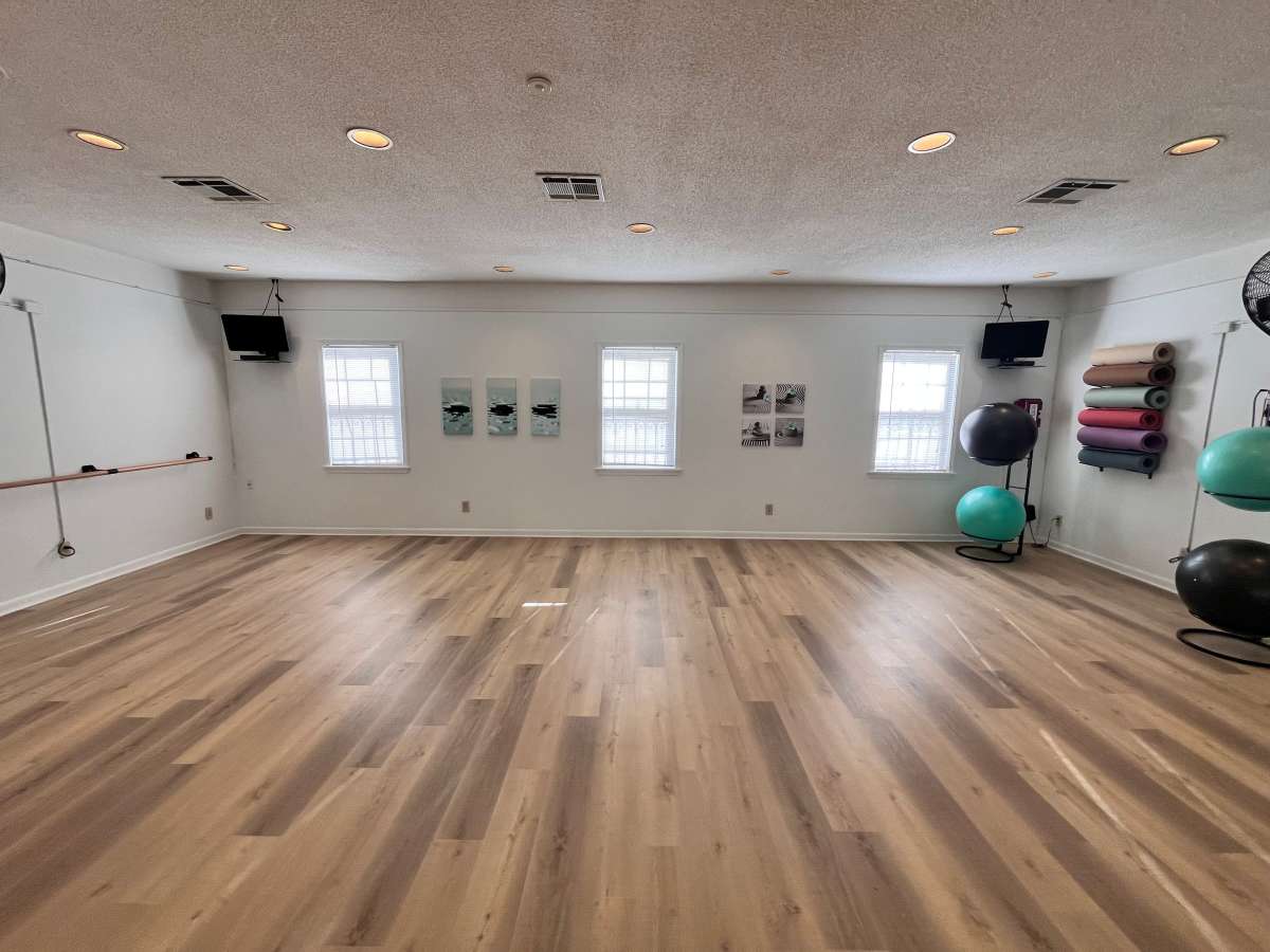 Yoga room with exercise ball and wood-style flooring at Georgetown Apartments in Merriam, Kansas