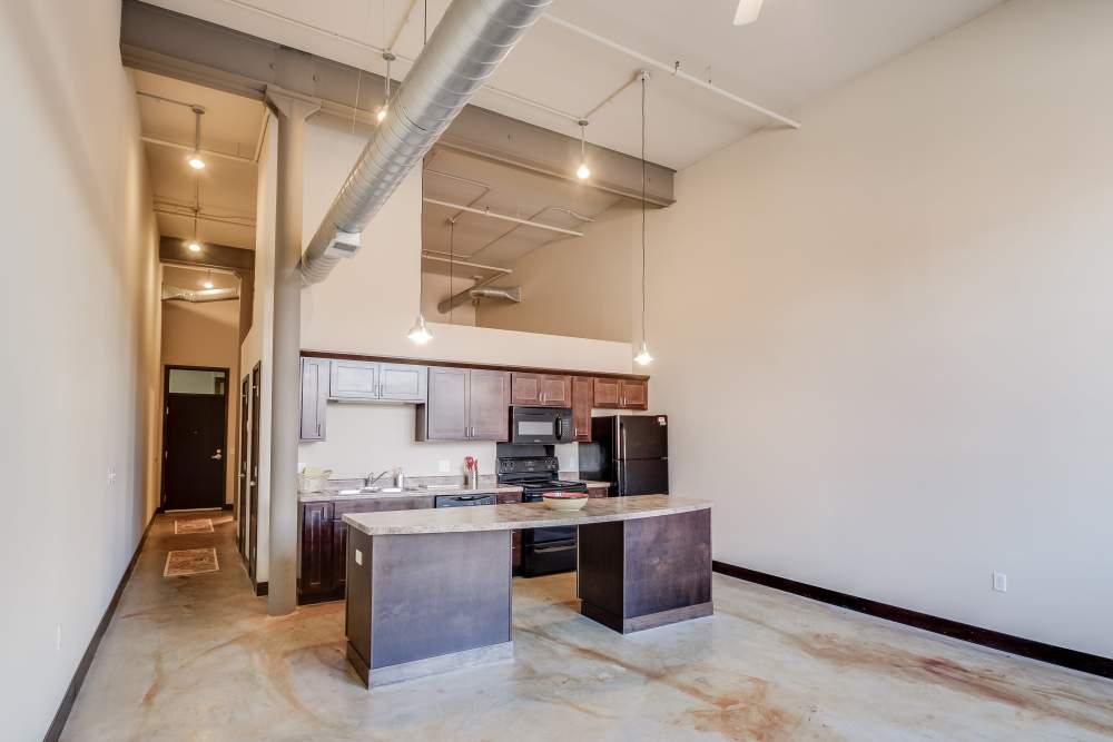 Kitchen island with countertop and appliances at Rumely Lofts in Des Moines, Iowa