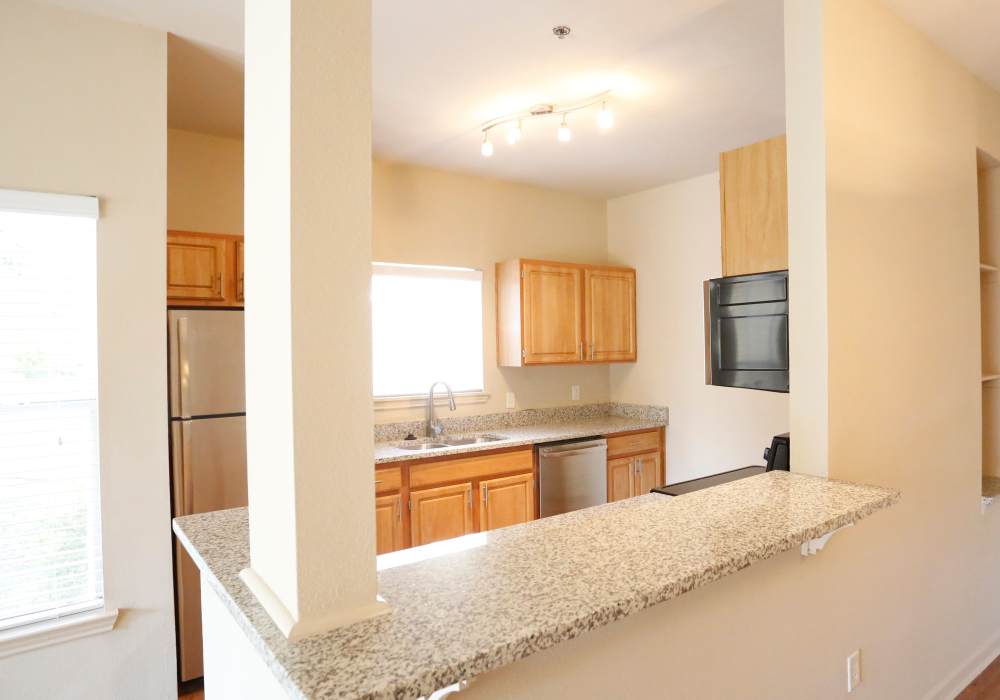 Granite countertop with wooden cabinets at Botanica in Mandeville, Louisiana