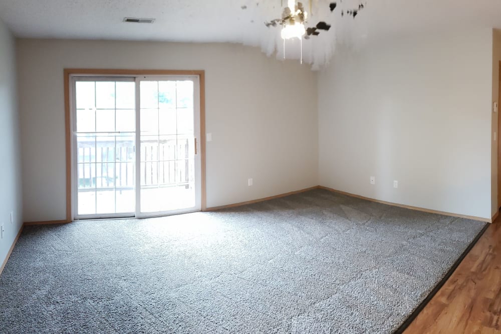 Large living room with soft carpet at Campbell Flats Apartments in Springfield, Missouri