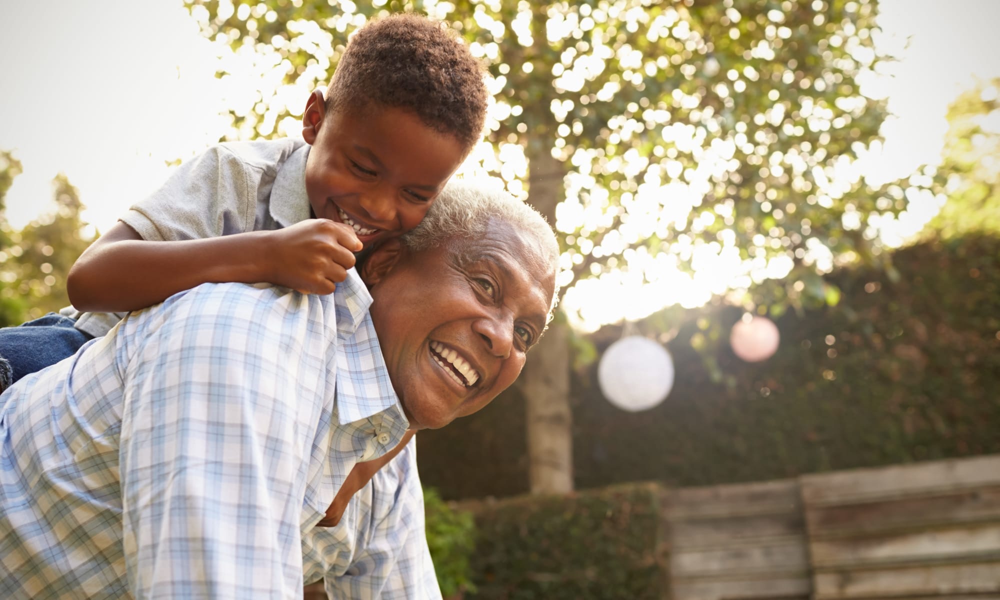 A resident of a Retirement Center Management community playing with their grandchild.