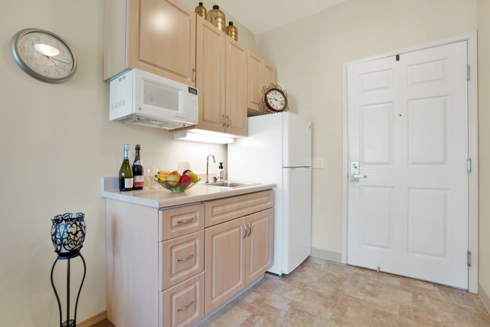 Kitchenette in senior living apartment at The Commons on Thornton in Stockton, California
