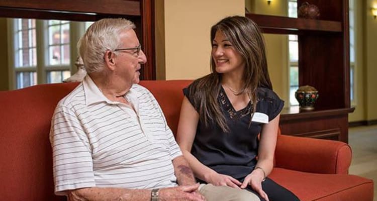 Caregiver talking with a resident at The Commons at Woodland Hills in Woodland Hills, California