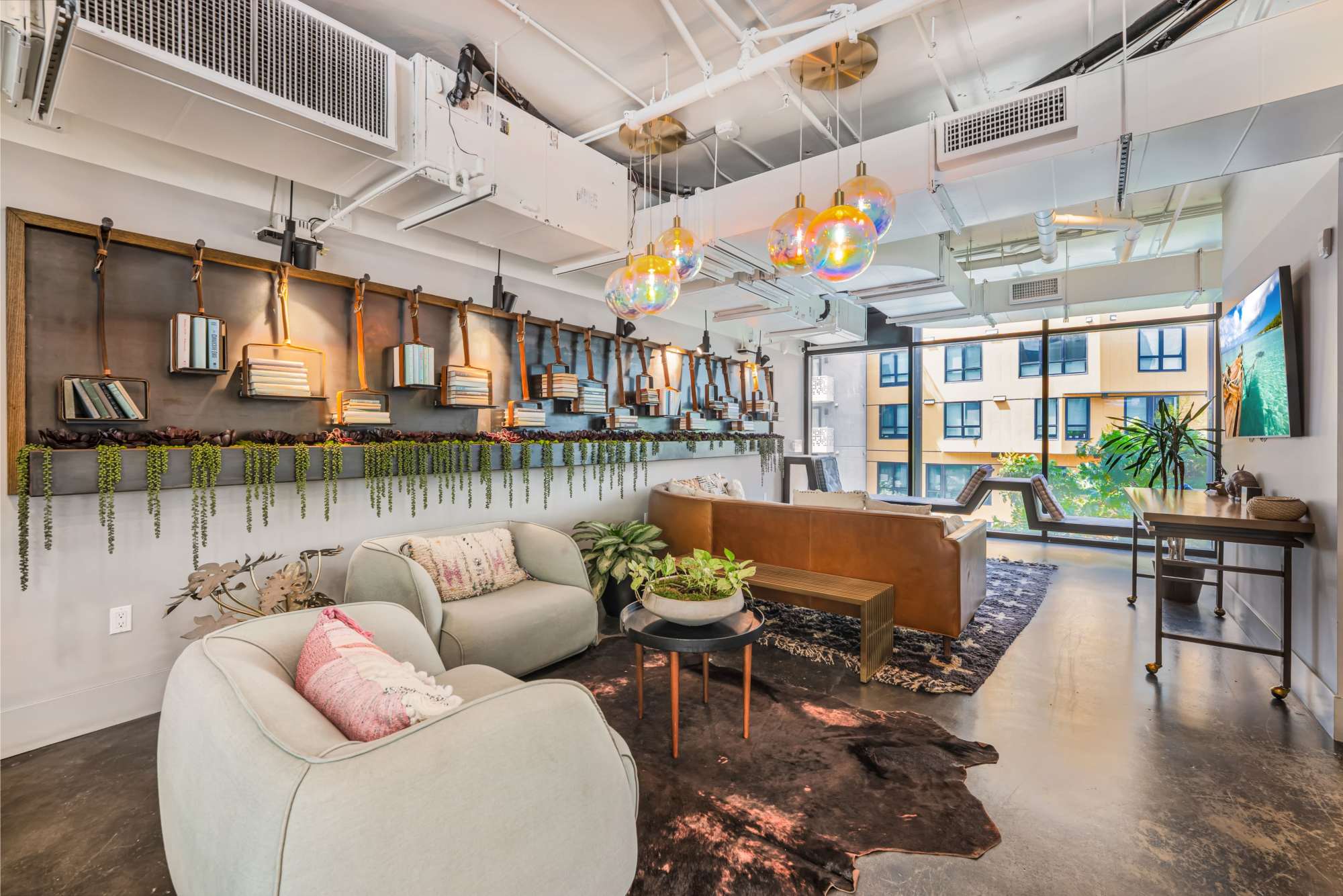 Large resident lounge with TV and large windows for beautiful lighting at The Artisan in San Diego, California