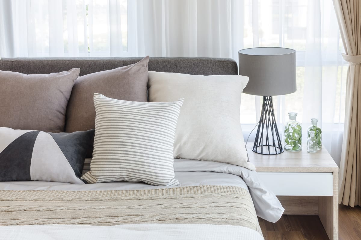 A decorated apartment bedroom at Carnegie Heights at Henderson in Henderson, Nevada