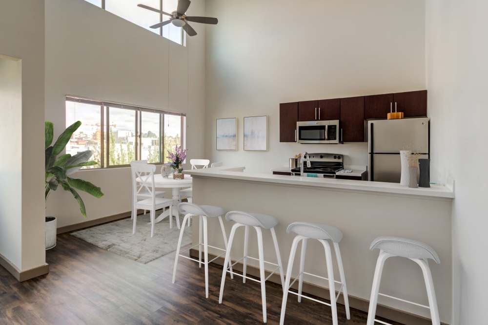 A kitchen with bar seating at Elan 41 Apartments in Seattle, Washington