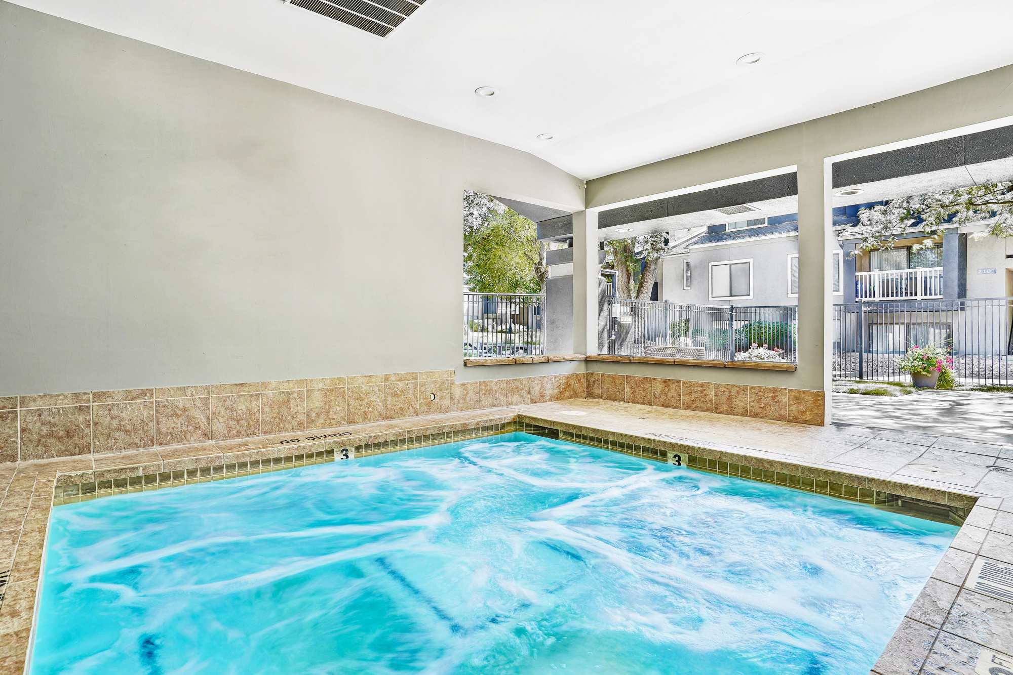 Bright indoor pool with seating at Royal Farms Apartments in Salt Lake City, Utah