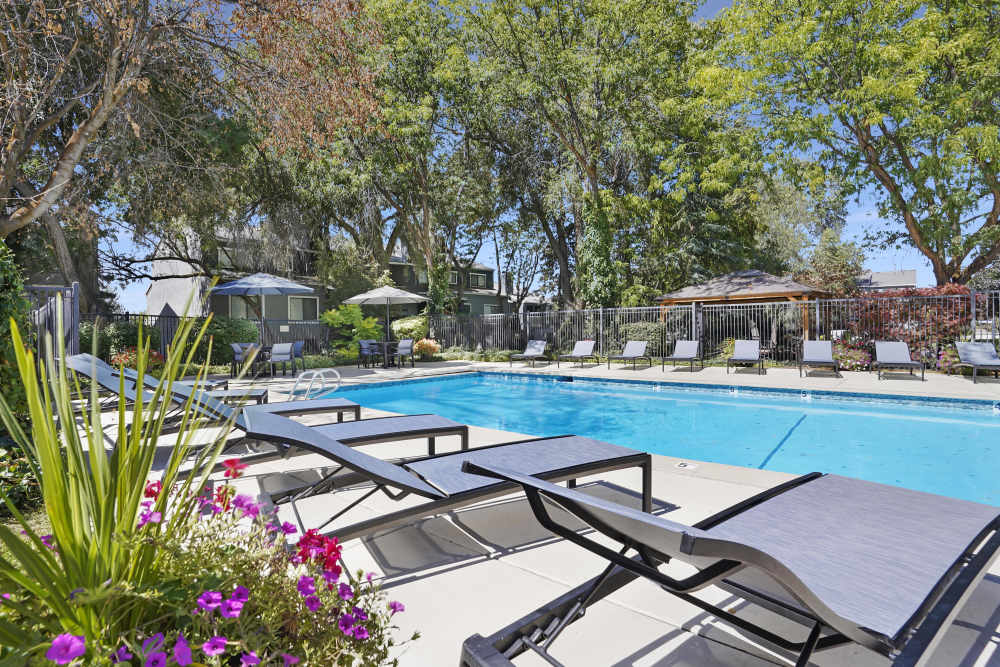 Pool with lounge chairs at Royal Farms Apartments in Salt Lake City, Utah