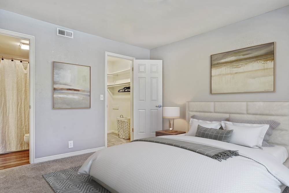 Bedroom with side lamp and window at Royal Farms Apartments in Salt Lake City, Utah