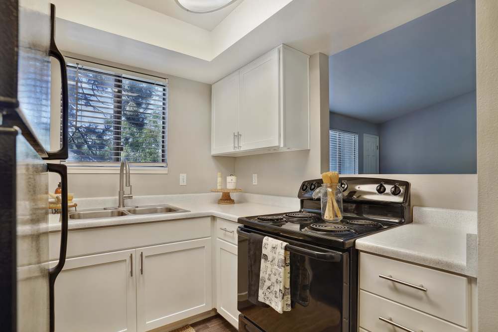 Updated kitchen with appliances at Royal Farms Apartments in Salt Lake City, Utah