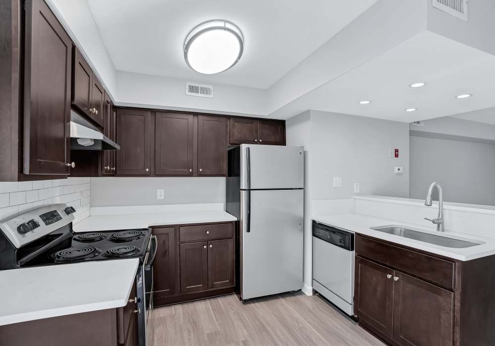 Kitchen with stainless-steel appliances and granite countertops at BayPointe Crossing in Virginia Beach, Virginia
