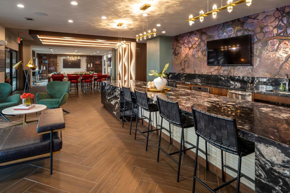 Interior of a clubhouse kitchen with seating space at Whitmore in Houston, Texas