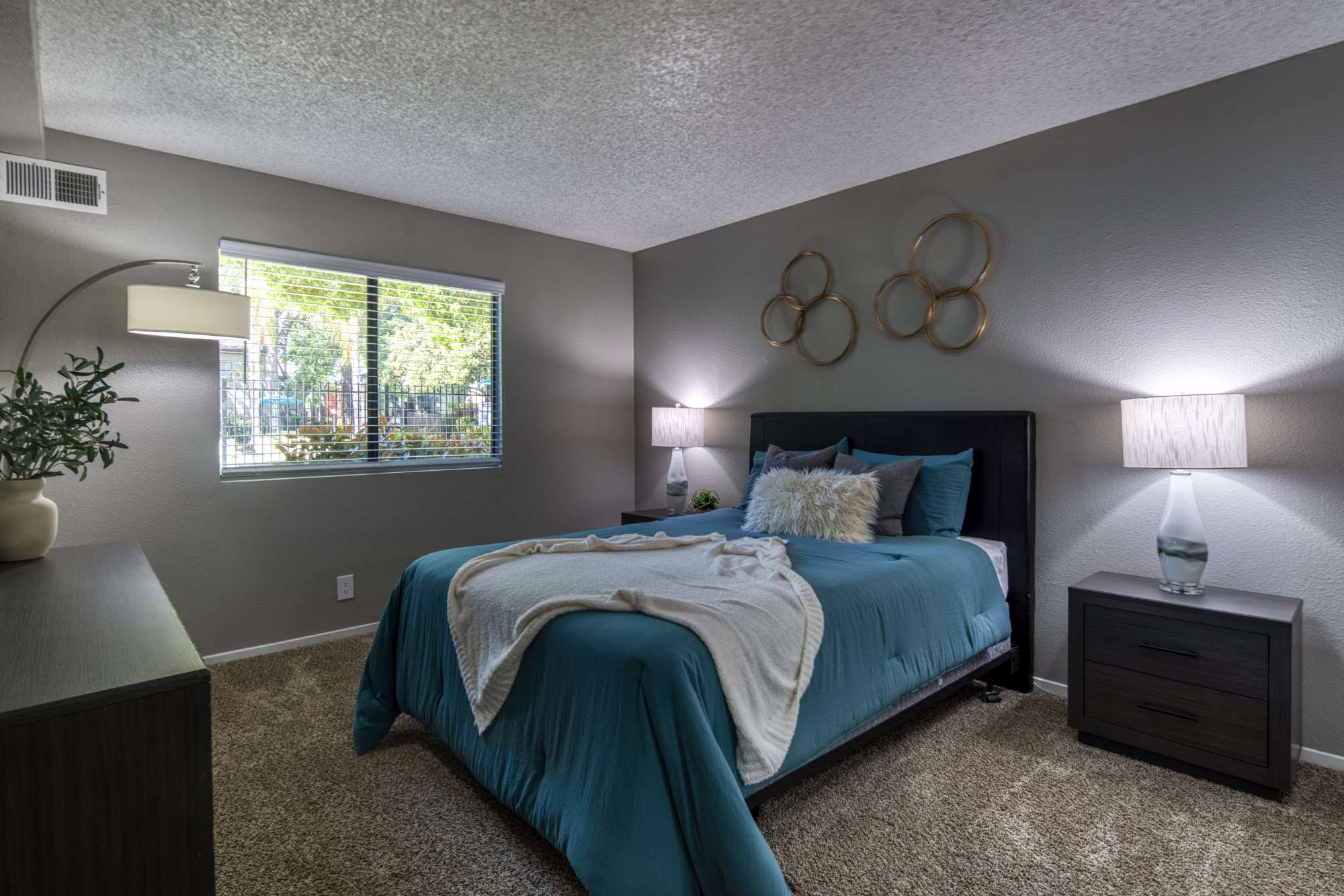 Spacious bedroom with carpet flooring at Falls at Arden in Sacramento, California