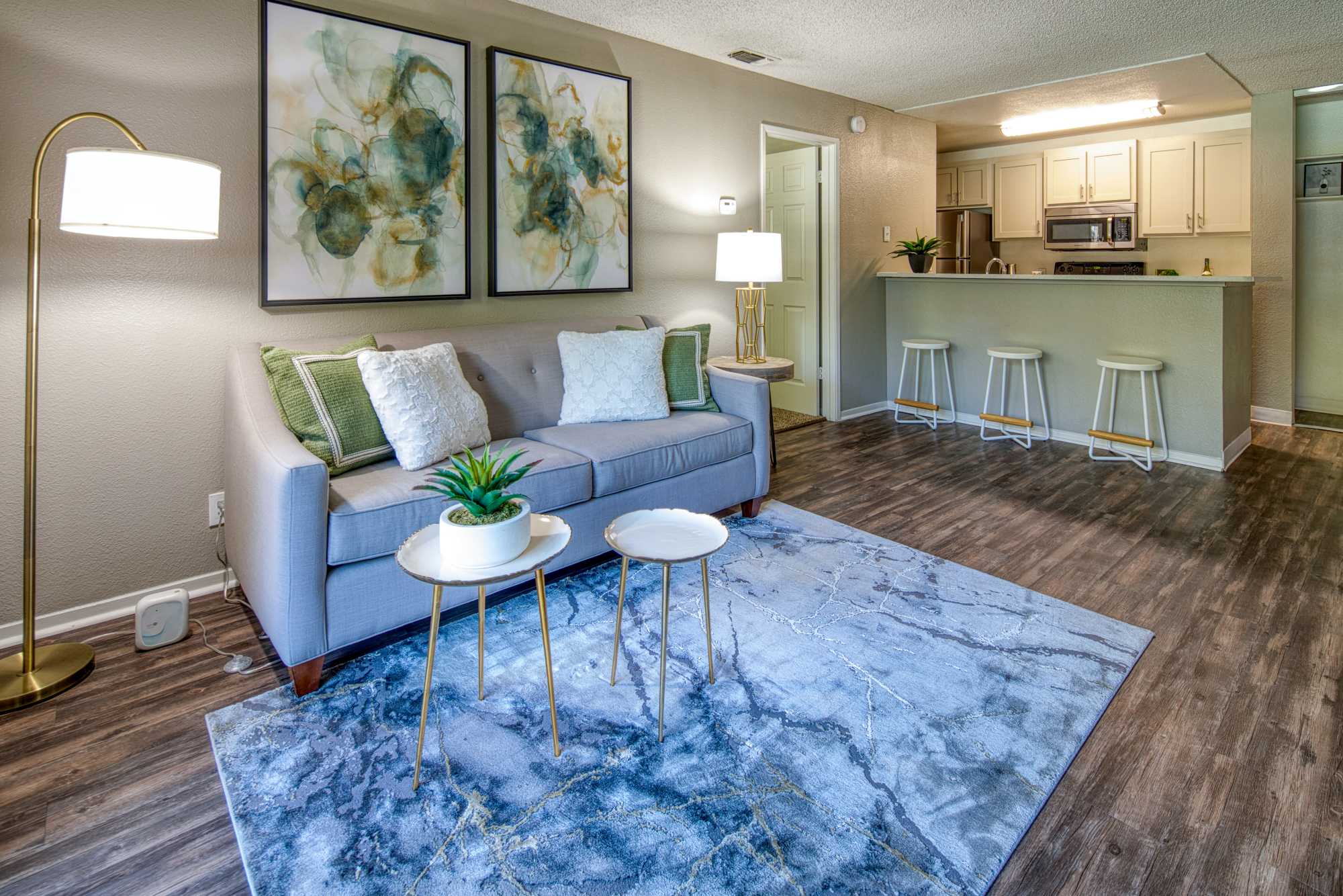 Living room with view to kitchen at Falls at Arden in Sacramento, California