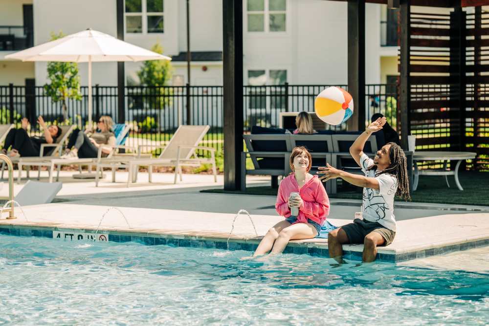Residents enjoying near a pool at The Waters at Promenade in Marrero, Louisiana