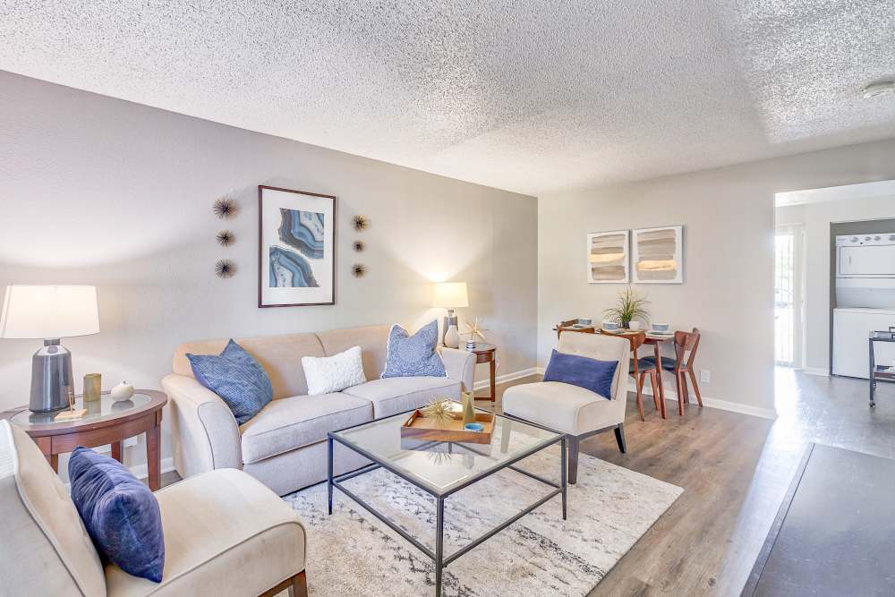 Well decorated living room interior at Broadmoor Ridge Apartment Homes in Colorado Springs, Colorado features hard wood floors.