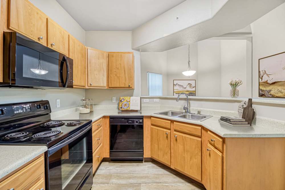 Beautiful kitchen with wooden cabinetry and appliances at The Lofts in Sacramento, California