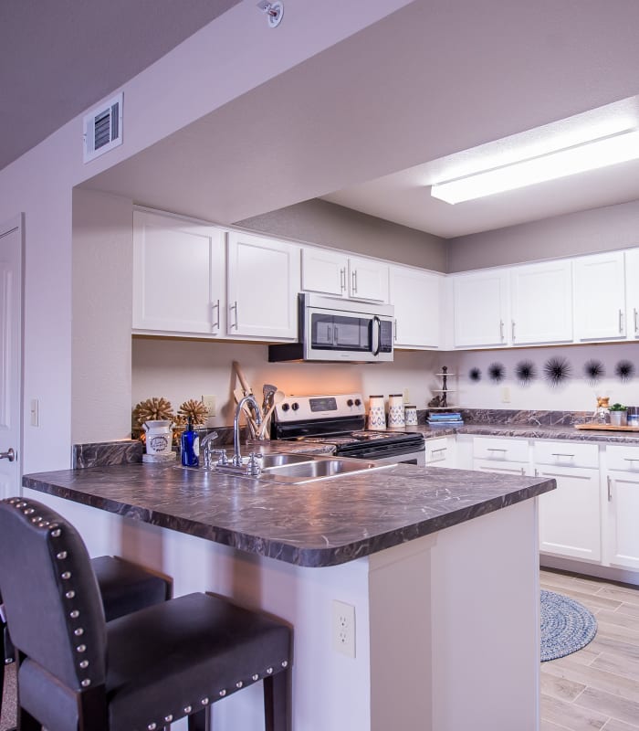 Kitchen with granite countertops at Scissortail Crossing Apartments in Broken Arrow, Oklahoma