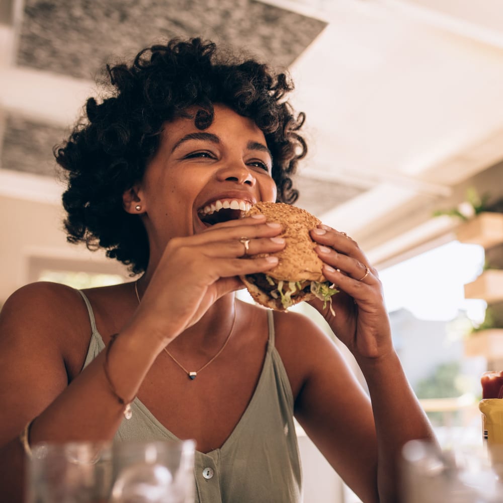 Resident eating a burger near LATITUDE on Hillsborough in Raleigh, North Carolina