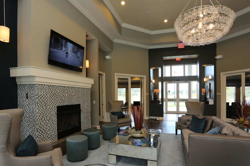 Interior clubhouse with fire pit and lots of windows at Adams Crossing Apartment Homes in Waldorf, Maryland