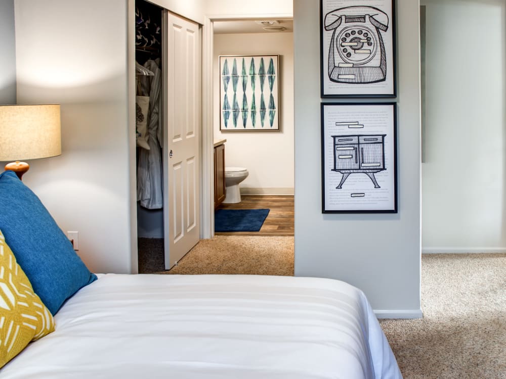 Master bedroom with plush carpeting and an en suite bathroom in a model home at Sofi at Cedar Mill in Portland, Oregon