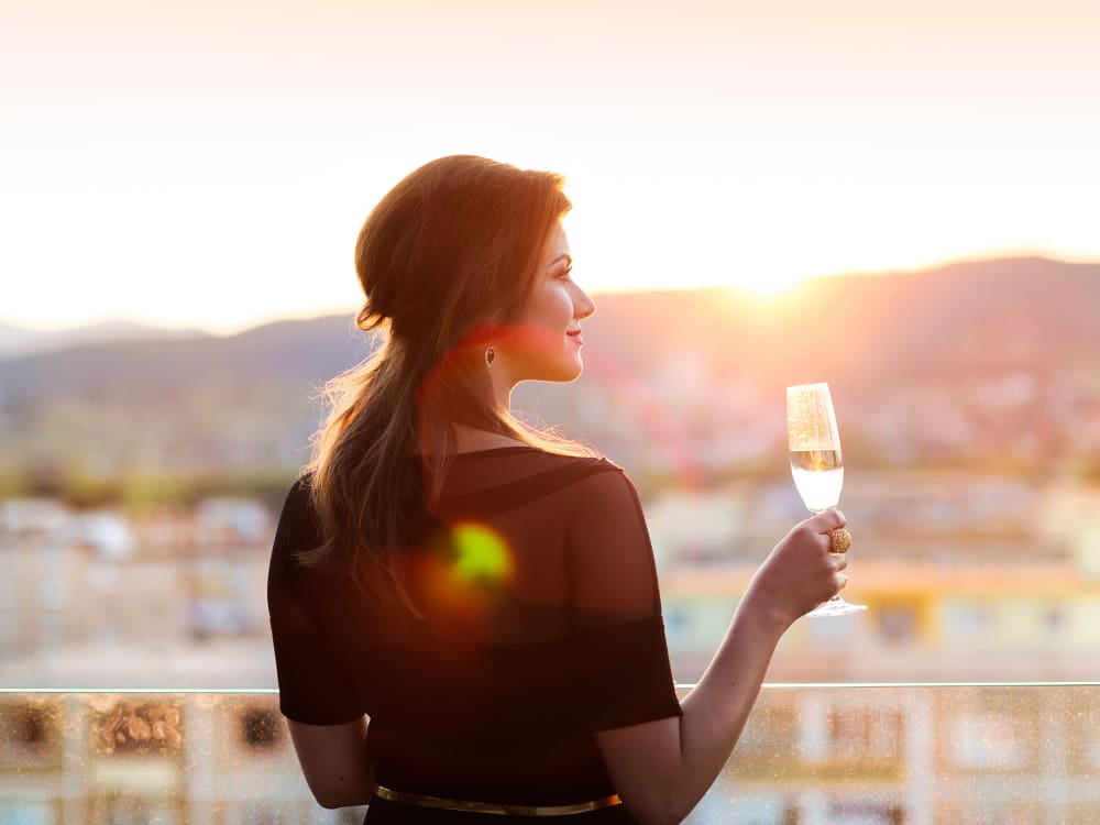 Resident enjoying a glass of wine at Allegro at La Entrada in Henderson, Nevada