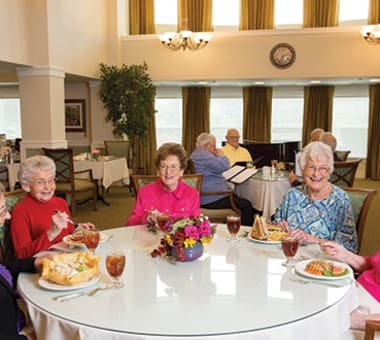 Seniors enjoying a meal together at Burr Ridge Senior Living in Burr Ridge, IL
