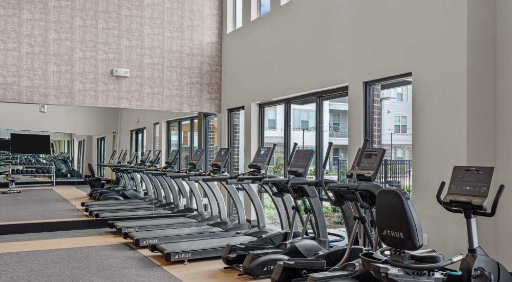 Fitness center with treadmills at Opal Point at Kyle in Kyle, Texas