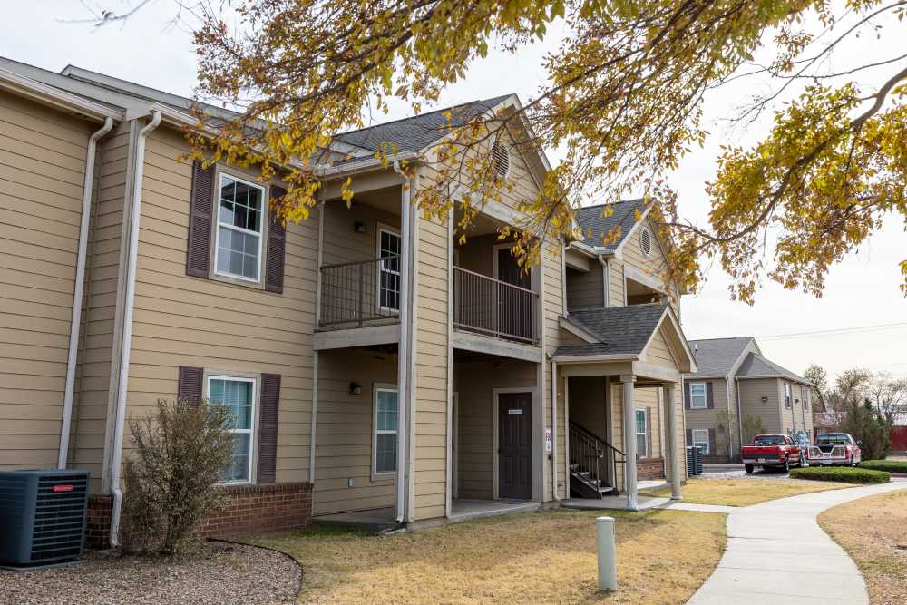 Charming two-story residence featuring inviting balconies and lush landscaping at Adobe Ranch in Borger, Texas.