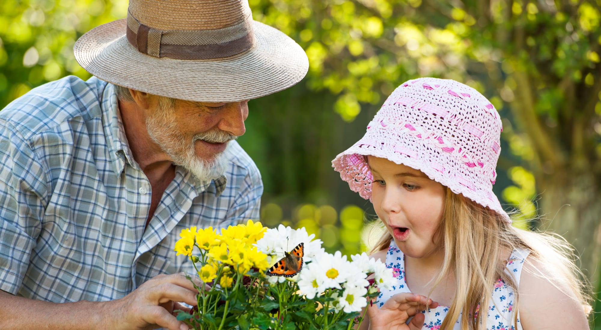 Resident and granddaughter picking flowers out near Sundial Assisted Living
