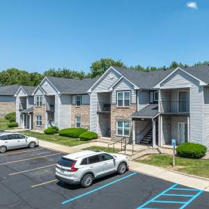 Apartment exterior with car parking facility at front side at Spring Lake Apartments in Granger, Indiana