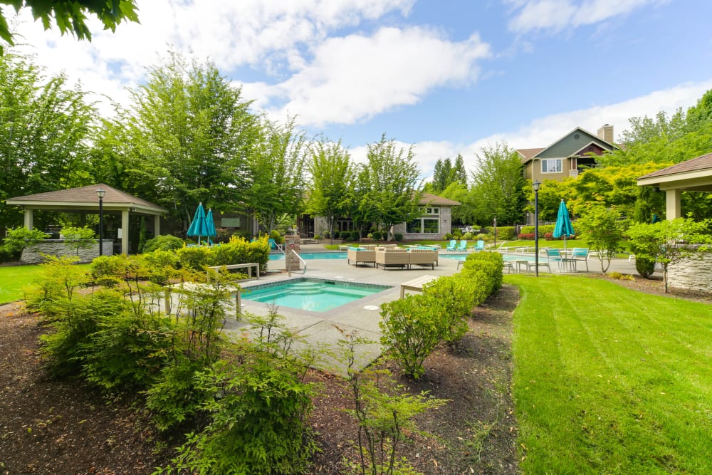 A hot tub with two benches next to it at The Grove at Orenco Station in Hillsboro, Oregon